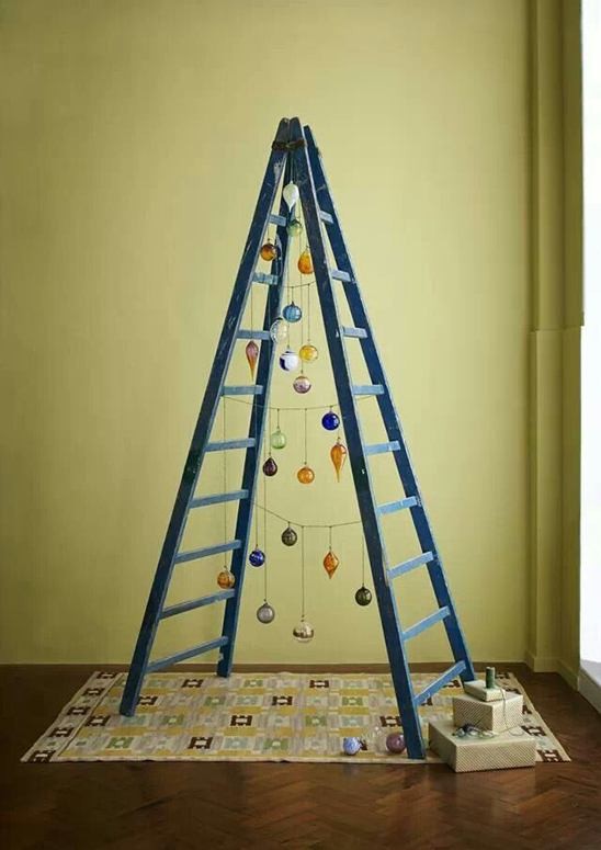 With a string of lights, some ornaments, and an A-frame ladder, you can make <a href="http://guide.weddingchicks.com/17-alternative-christmas-trees/" target="_blank">the coolest anti-tree ever</a>.