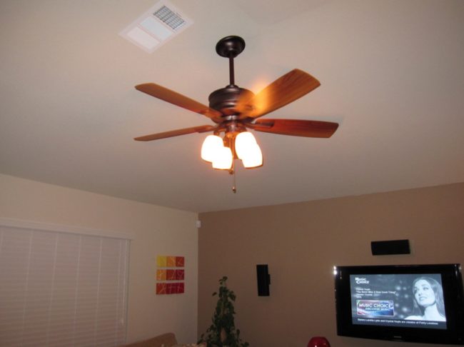 Run your ceiling fan on low and spin it clockwise. It will help warm air make it back down to ground level.