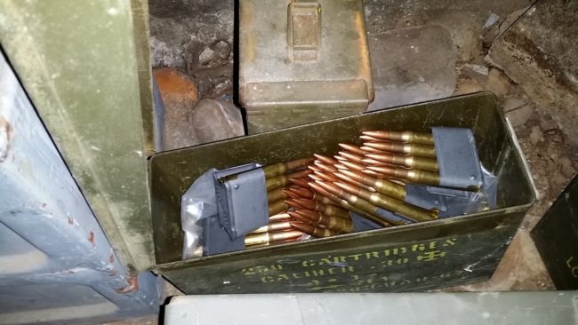 In a secret room, one man found tons of ammunition, guns, and grenades.