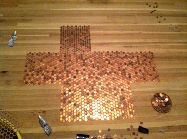 This process was a tedious one, since each penny had to be glued to the floor individually.