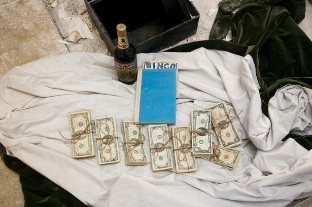 A couple found this 50-year-old safe hidden in the wall with $51,000 inside. It also held a bottle of bourbon and a book titled <em>A Guide for the Perplexed</em> by E.F. Schumacher.