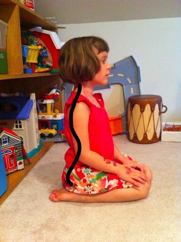 And here's what happens when little ones tuck their legs under their bums instead. While they'll still have to reach down to play with their toys, the position helps stabilize and support the lumbar regions of their backs.