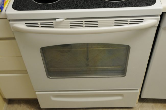 Use your oven to cook more. It will warm your kitchen and adjacent rooms.