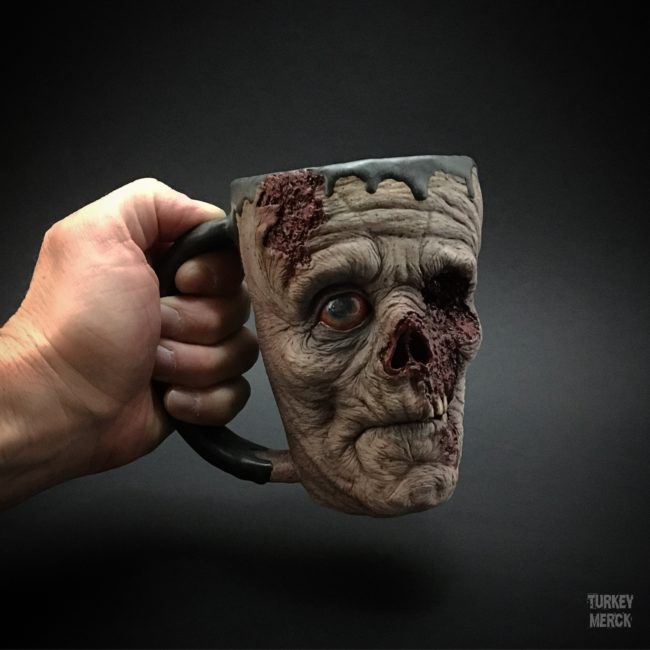 Presumably tired of seeing mugs plastered with psuedo-profound nonsense and cutesy illustrations, Merck used his affinity for intricate sculpture and flair for horror to come up with something a little more grisly.