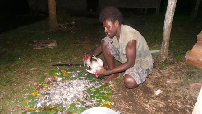Her cousin Gabriel is the cook. Here he is preparing a chicken for their Christmas dinner.