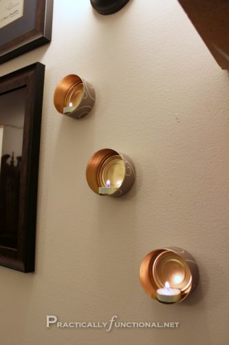 Mounted <a href="http://www.practicallyfunctional.com/wall-mounted-tin-can-tea-lights/" target="_blank">tin can tea lights</a> add just a touch of romance to any room.
