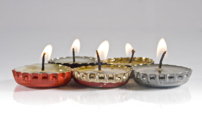 Mini bottle top candles are <a href="http://draftmag.com/how-to-bottle-cap-candles/" target="_blank">super easy</a> to make.