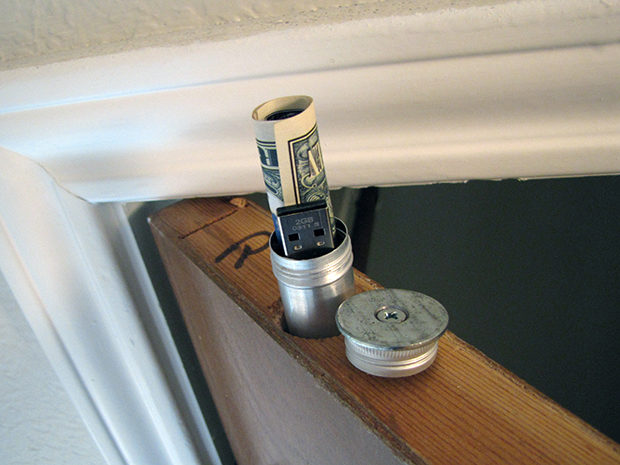 Drill a hole and hide things in your door.