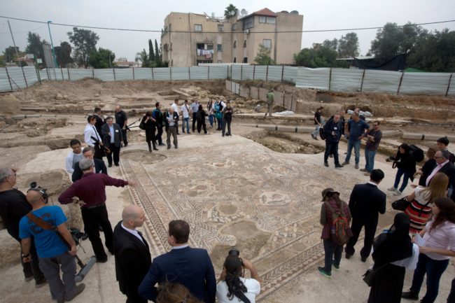 Bystanders, archaeologists, and reporters alike crowded around the incredible scene to look upon what was once the floor of a wealthy household.