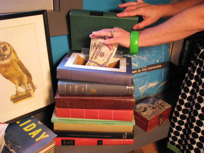 Hide things in a stack of vintage, hollowed-out books.