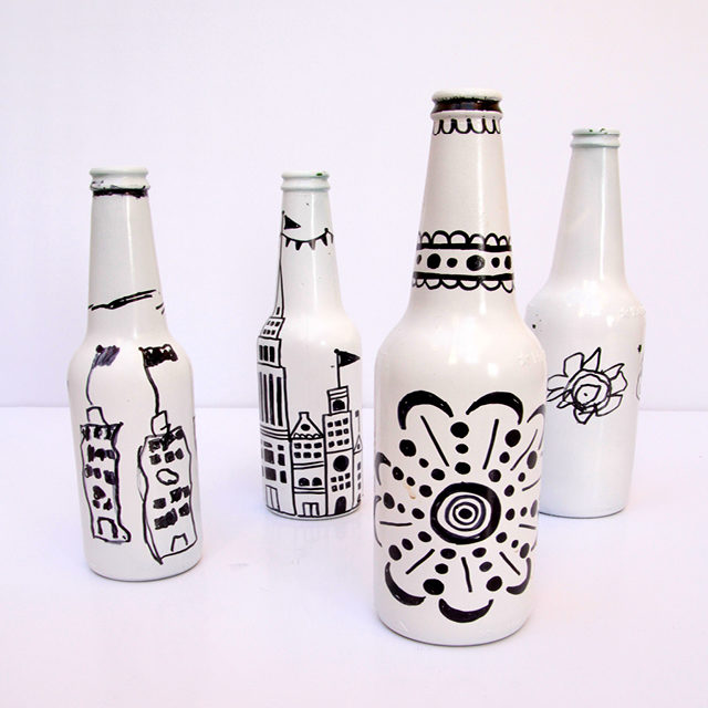 For a simple statement piece in your home, just paint your bottles white and decorate them with Sharpies.