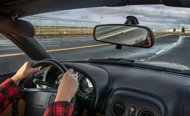 Driving a car.